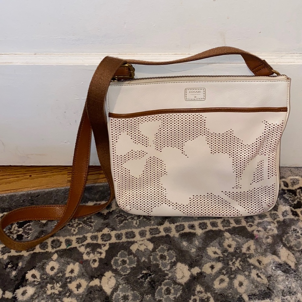 Fossil crossbody floral perforated design leather flat bag.